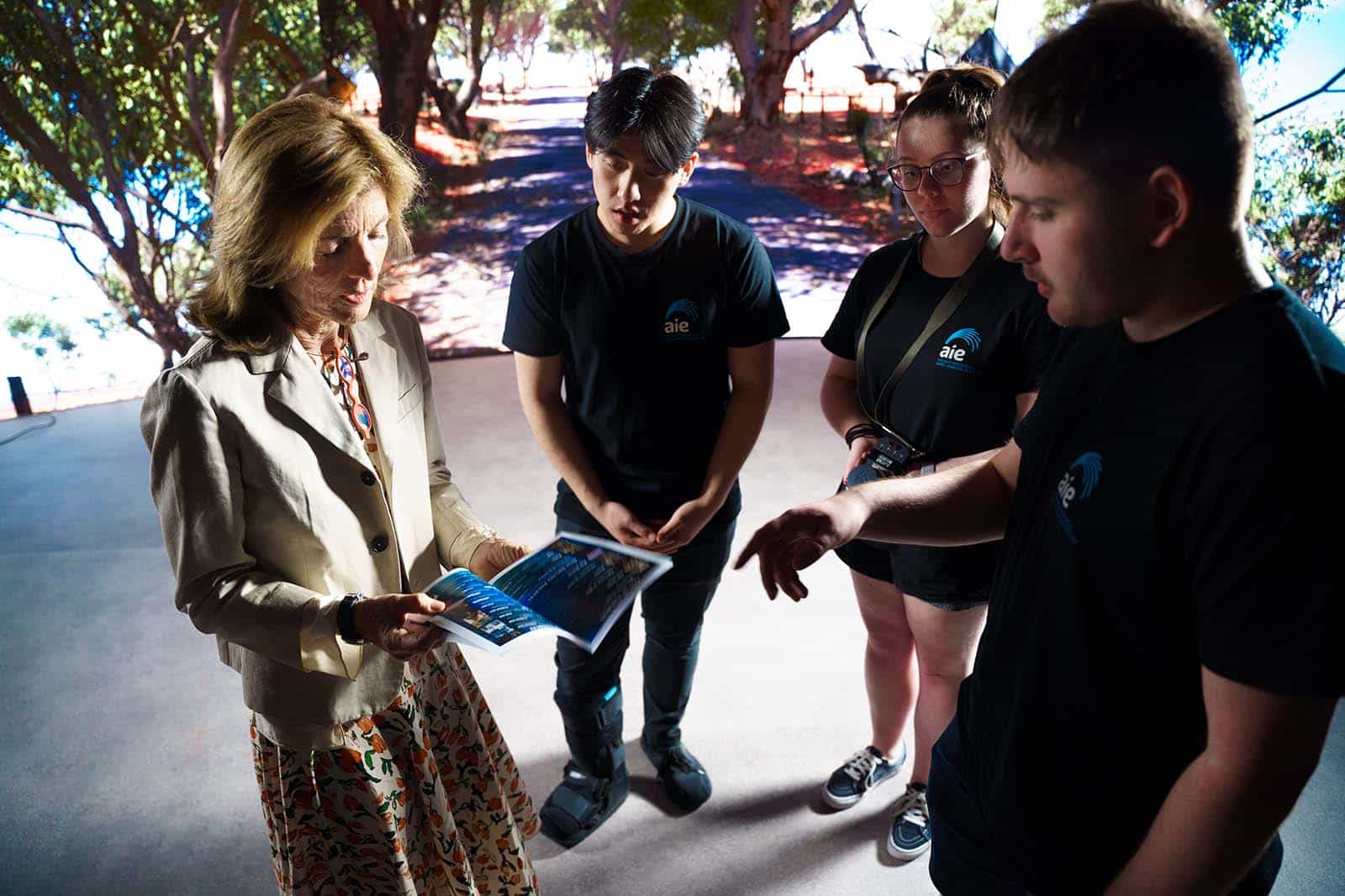 Ambassador Kennedy with AIE Film Students in front of the LED virtual production screen. 