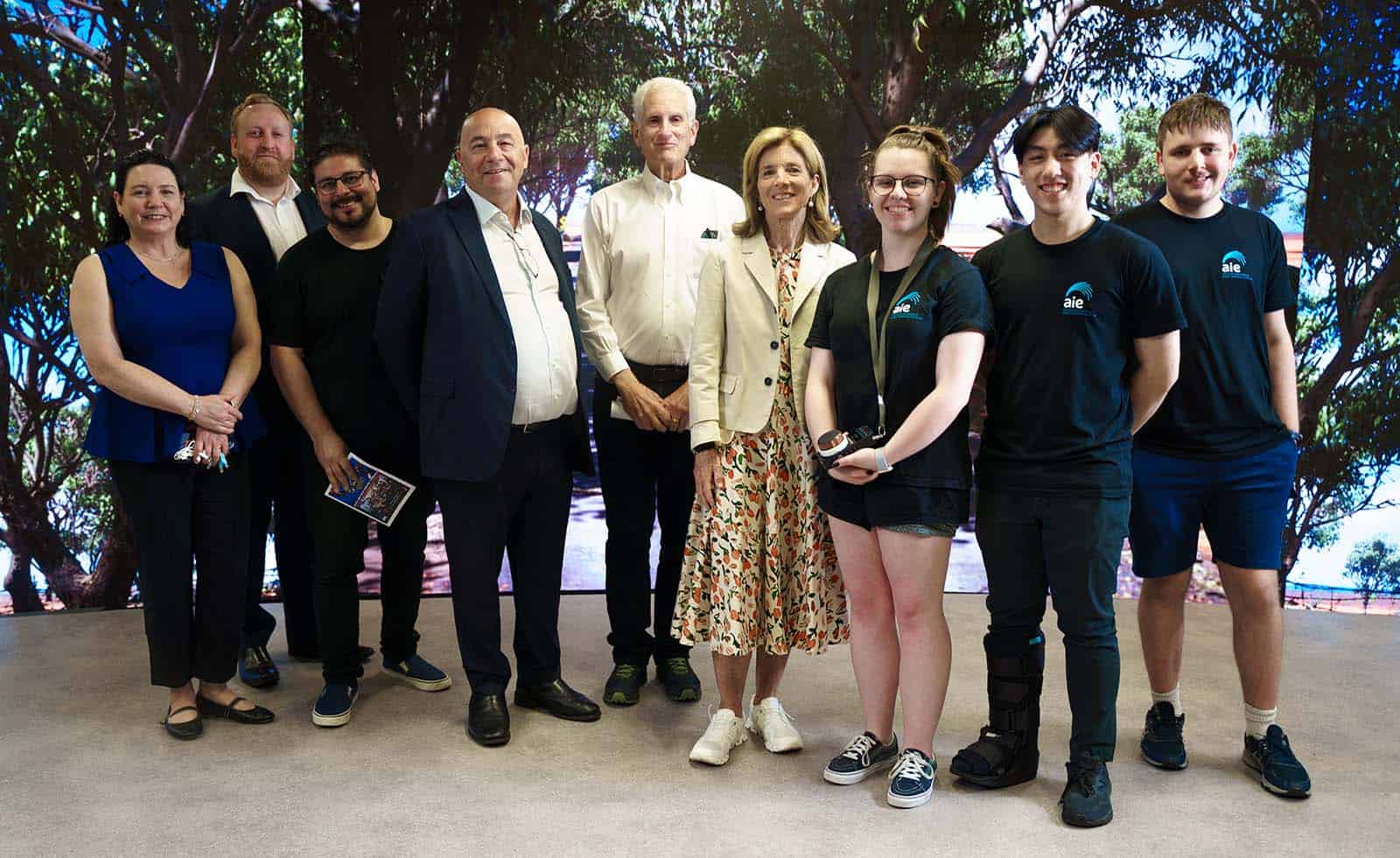 Ambassador Kennedy and Dr Schlossberg with AIE staff  and students. (L to R) Lea Michael, Josua Skeates, Dan Sanguineti, John De Margheriti, Dr Edwin Schlossberg, Ambassador Caroline Kennedy, Jaime Burgess, Joey Khuu and Anthony Riches.